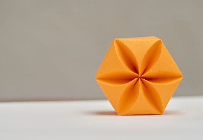 Caja de origami hecha a mano de color naranja, obra de Cartoncita
